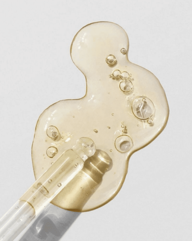 Targeted skincare serum being applied with a glass dropper for deep skin penetration.