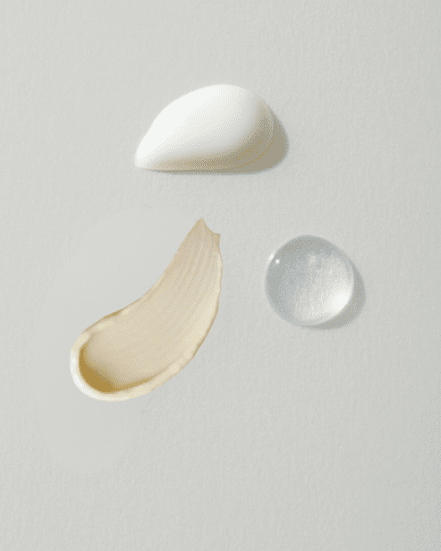 Comparison of skincare textures showing a rich white moisturizer, a smooth tan-colored cream, and a clear hydrating serum drop.